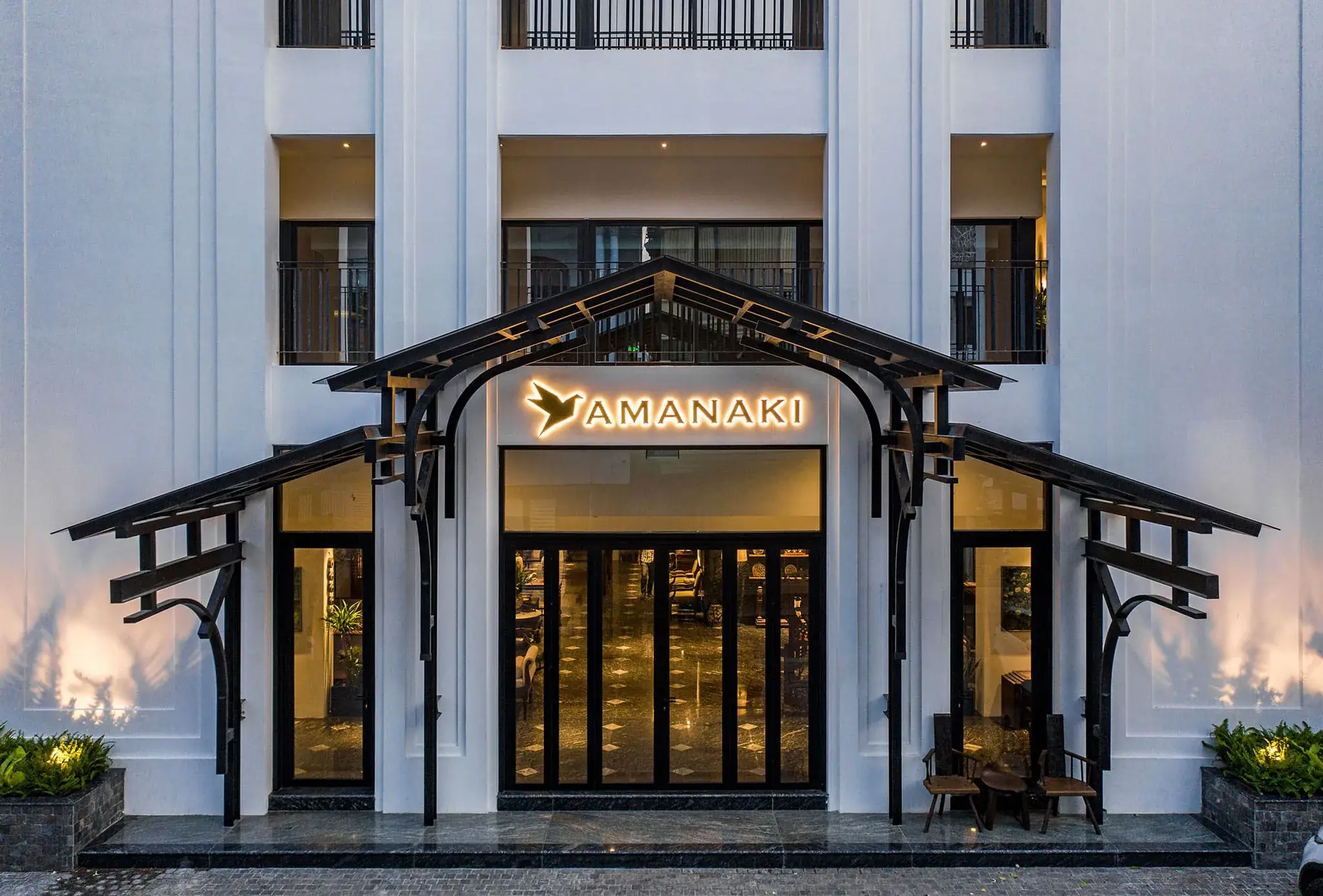 The entrance of Amanaki, an Auno Group boutique hotel, at dusk